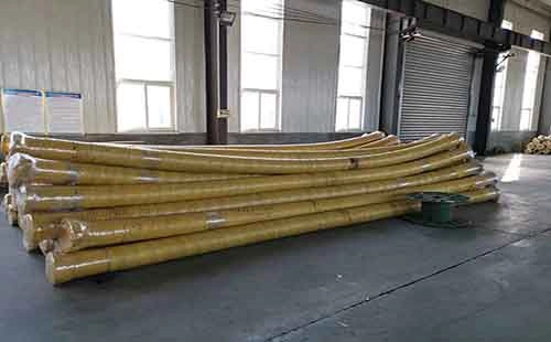 large industrial suction hoses wrapped in yellow protective covering