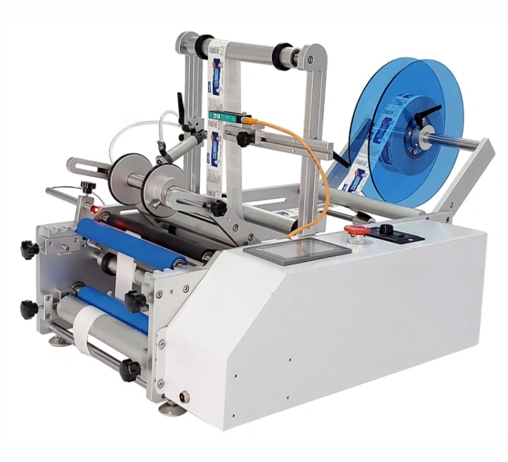 Desktop automatic labeling machine for bottles and flat surfaces.